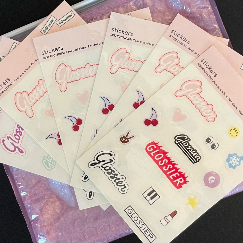 Glossier sticker pack with complimentary pink pouch